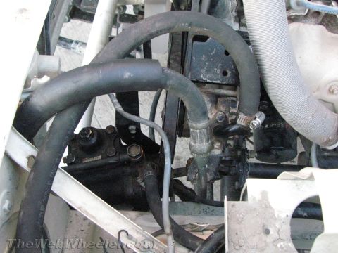 1987 Suzuki Samurai - This image shows the power steering system components of a vehicle, including hoses and the pump itself.