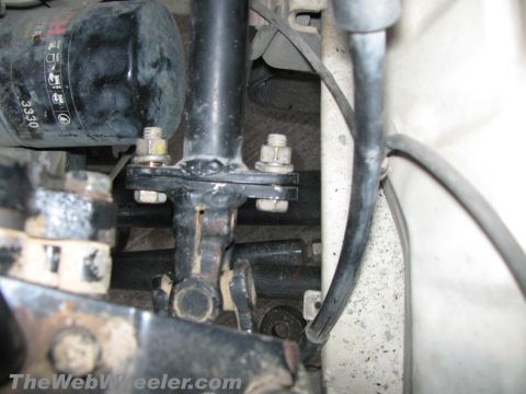 1987 Suzuki Samurai - Close-up view of the steering column linkage and a black oil filter, with a watermark at the bottom.