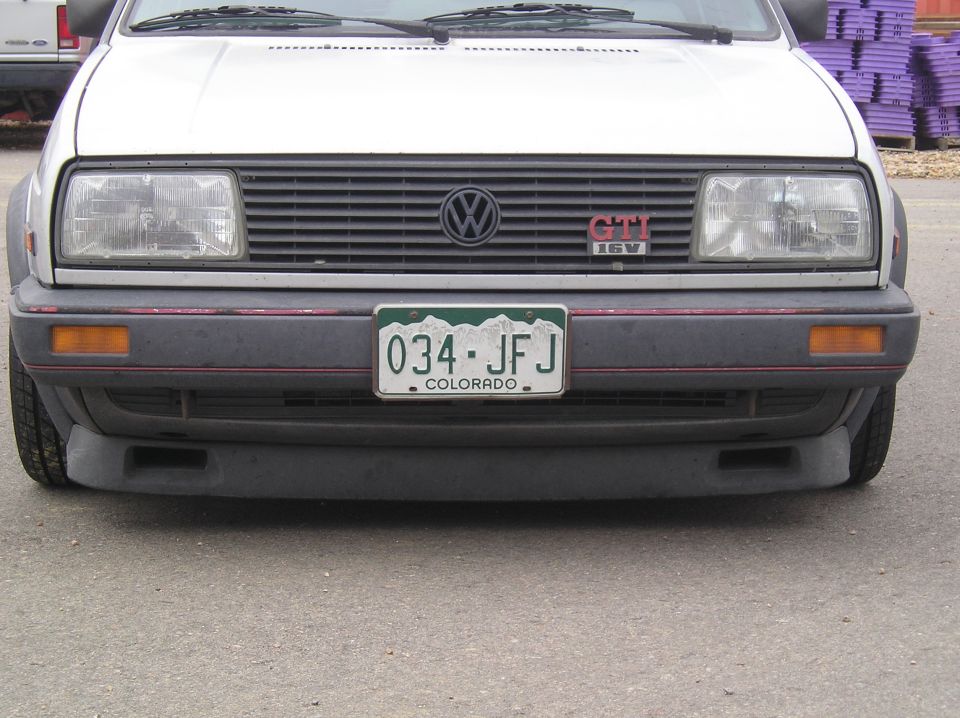 Front view of a white Volkswagen GTI with a Colorado license plate reading 034-JFJ