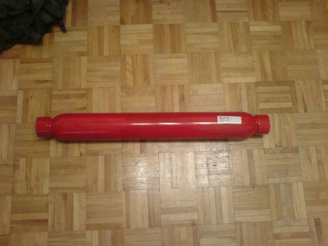 1985 Ford Bronco - A red shock absorber is shown on a parquet floor. The registry claims it is from a 1985 Ford Bronco, but this is unconfirmed.