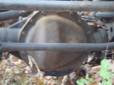 1996 Ford Bronco - Close-up of a vehicle's rear differential, partially obscured by metal bars.