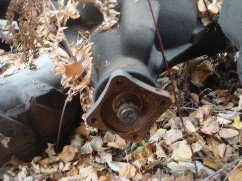 1996 Ford Bronco - Close-up of a rusted metal component lying on the ground with fallen leaves.