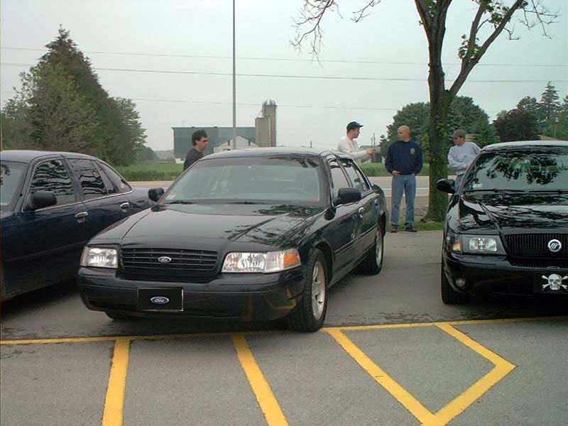Black 2000 Ford Crown Victoria parked in a lot