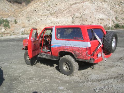 1985 Ford Bronco - This 1985 Ford Bronco is ready for off-road adventures, with its doors open and spare tire mounted.