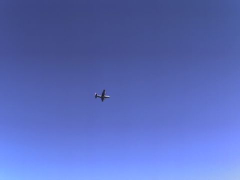 1988 Ford Bronco - Airplane in flight against a clear blue sky, with a Supermotors.net watermark.