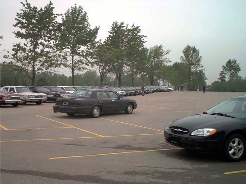 Dark sedan parked in a lot, 2000 Ford Crown Victoria