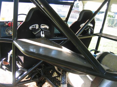 1992 Ford Mustang - Interior view of a modified vehicle, possibly a 1974 Bronco, racing seats, a roll cage, and a fire extinguisher.