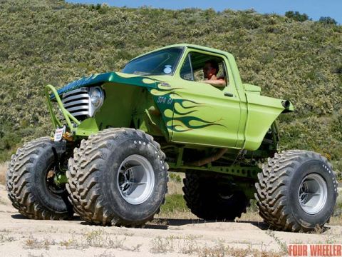 1991 Ford Bronco - This heavily modified truck features oversized tires and flame graphics, resembling a 1970s Ford F-Series.