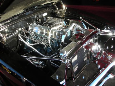 1998 Ford Crown Victoria - highly polished chrome-plated V8 engine with a round air cleaner sits in a mirror-finished black engine bay.