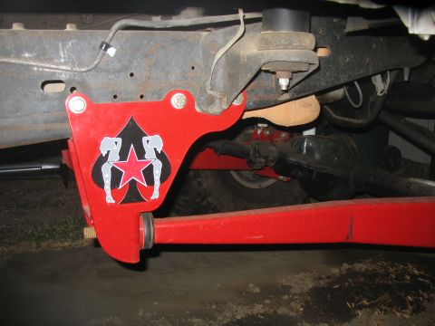1987 Ford Bronco - Close-up of a red suspension component with a spade and star graphic is visible on a vehicle.