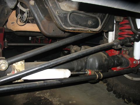 1987 Ford Bronco - Close-up view of a vehicle's suspension system, showing linkages and a differential.