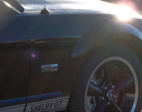 1978 Ford Bronco - A close-up shot of a black Ford Mustang Shelby GT, highlighting its side profile and distinctive racing stripes.