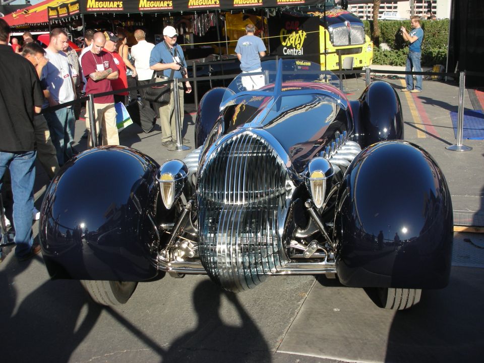 Front of dark blue art-deco streamlined custom car with chrome grille