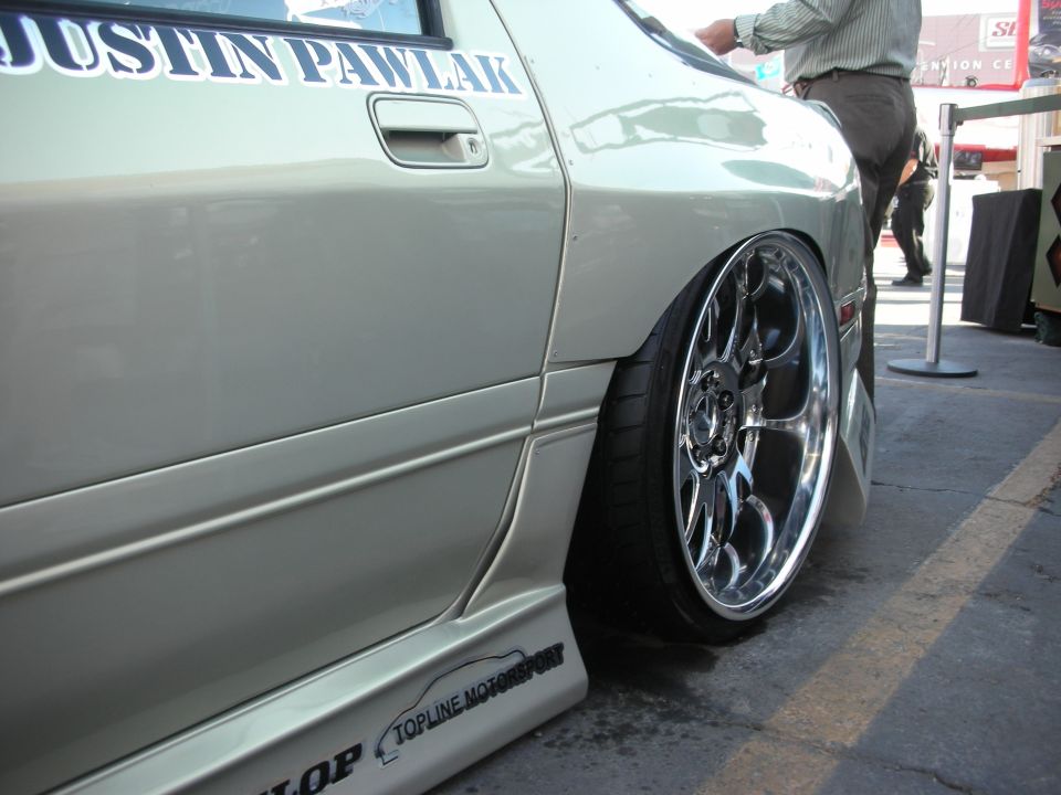 Close-up of green coupe rear fender, chrome wheel and JUSTIN PAWLAK lettering