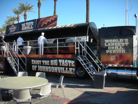 1998 Ford Crown Victoria - Johnsonville Big Taste Grill semi-trailer billed Worlds Largest Grill, with cooks at the rail and palm trees behind.