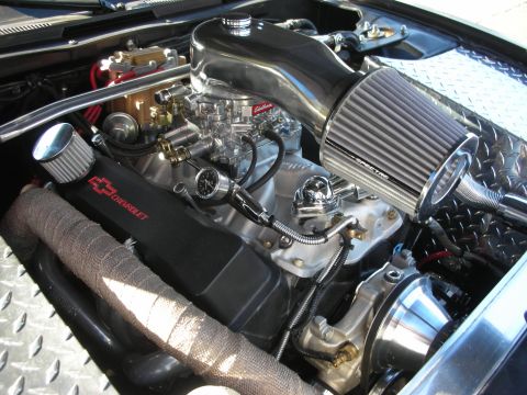 1998 Ford Crown Victoria - polished V8 with an Edelbrock carburetor, chrome air filter and Chevrolet valve cover sits in an engine bay.