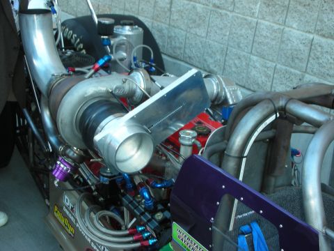 1998 Ford Crown Victoria - massive turbocharger and polished exhaust piping dominate the diesel engine of a rail dragster.
