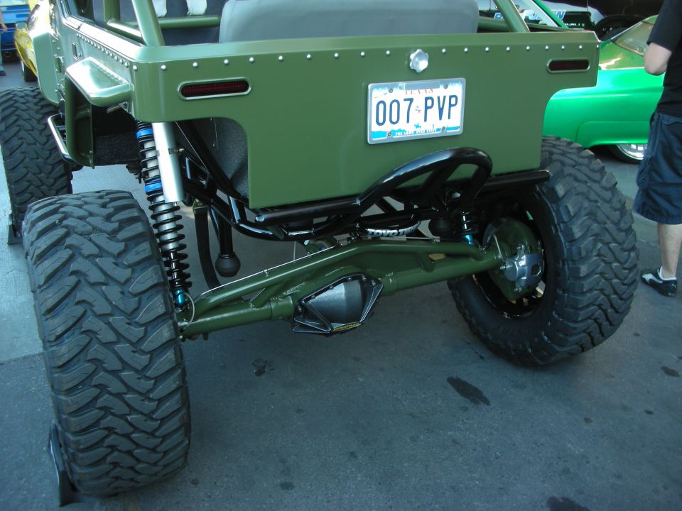 Rear of olive-green tube-chassis buggy with Nevada plate 007 PVP on big tires