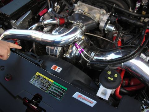 1998 Ford Crown Victoria - Close-up of polished aluminum intake piping, throttle body and supercharger plumbing in a custom-built engine bay.