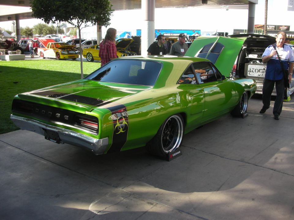 Green Dodge muscle car with biohazard graphic at outdoor car show