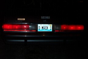 1990 Mercury Grand Marquis - Car's rear end with illuminated taillights and a custom license plate.