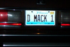 1990 Mercury Grand Marquis - The rear of a vehicle is shown, an Illinois license plate with the text 'D MACK 1'.