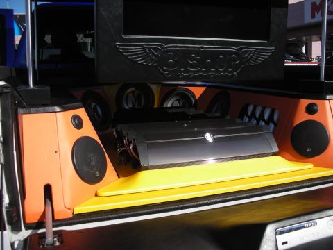 1998 Ford Crown Victoria - custom tailgate audio display with an amplifier, orange enclosures and speakers under an engraved 'Big Shop' winged panel.