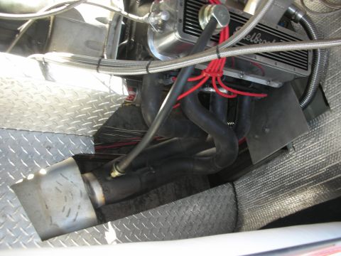 1998 Ford Crown Victoria - Close detail of an engine bay showing black exhaust headers, braided fuel lines and a diamond-plate aluminum floor.