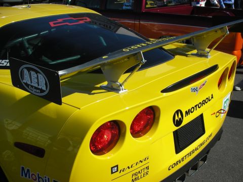 1998 Ford Crown Victoria - Close-up of a yellow Corvette race car's rear wing, tail lights and Motorola, AER and Corvette Racing decals.