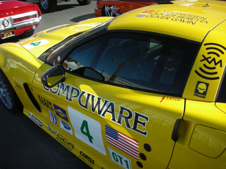 Yellow Corvette GT1 race car side with Compuware livery, US flag and number 4