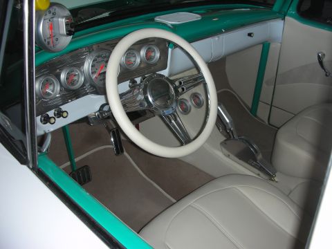 1998 Ford Crown Victoria - custom car interior in green and cream with a white steering wheel, white bucket seats and a row of chrome auxiliary gauges.
