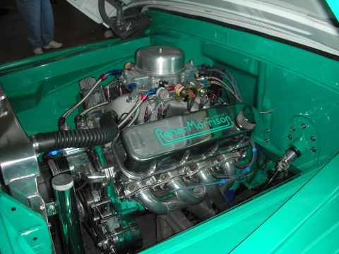 1998 Ford Crown Victoria - polished V8 engine with chrome accents and Reher Morrison valve covers mounted in a teal-painted engine bay.