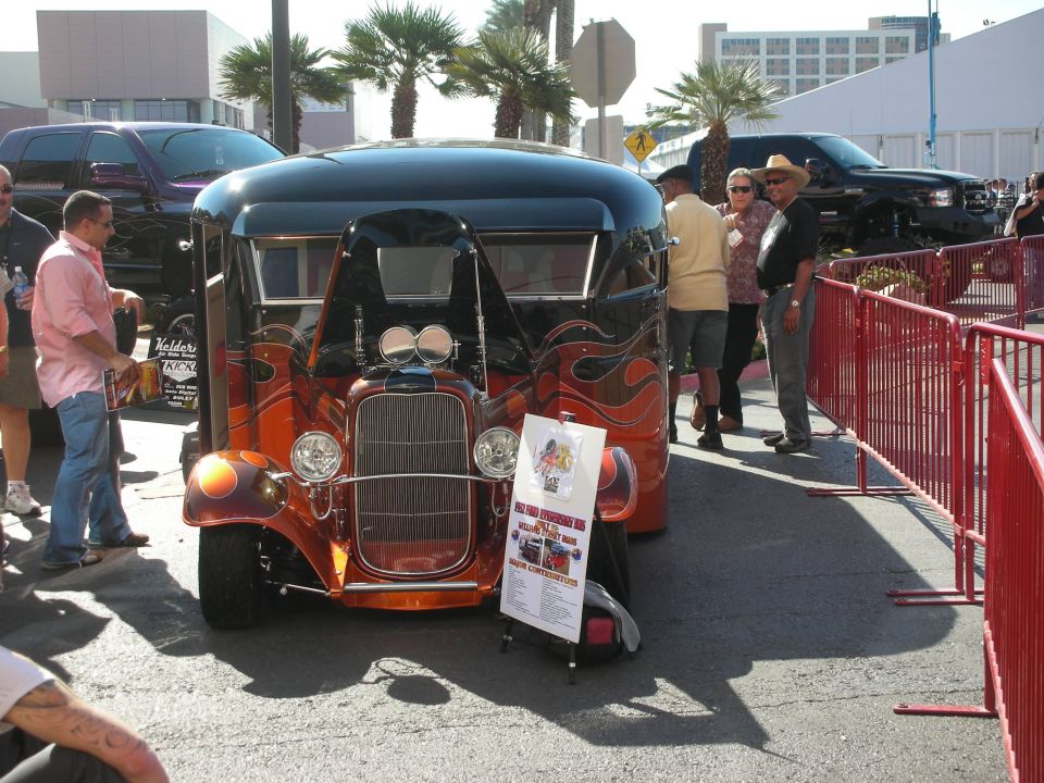 Orange flamed hot rod hauler with twin spotlights at outdoor car show