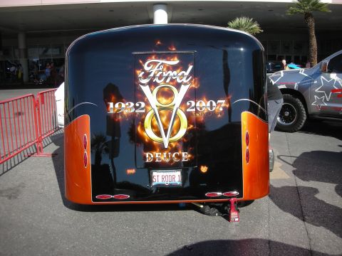 1998 Ford Crown Victoria - Rear view of a black and orange enclosed trailer airbrushed with a flaming Ford V8 Deuce 1932-2007 logo and a ST RODR 1 license plate.