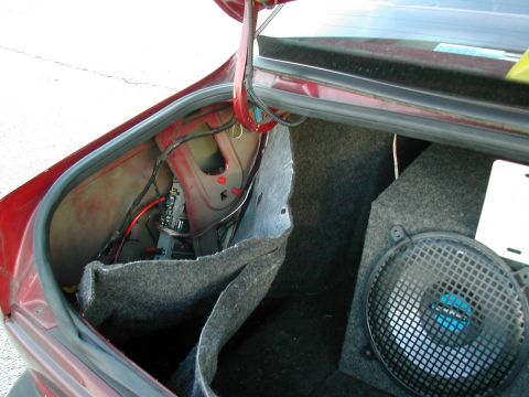 1991 Ford Taurus - Here's another shot of that amp install. I hid it nicely behind the carpeting in the trunk. I've had no overheating problems with it there.