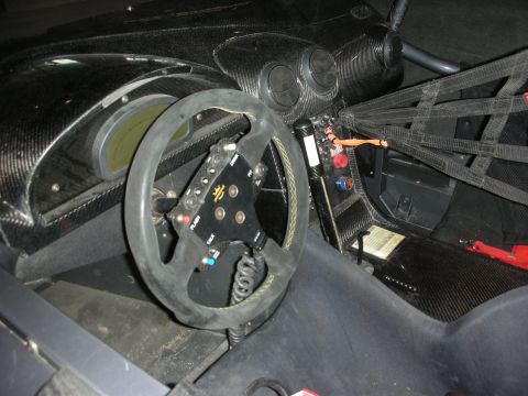1998 Ford Crown Victoria - Stripped race car cockpit with carbon-fiber dash, a suede-rimmed steering wheel with switches, racing harness and digital gauges.