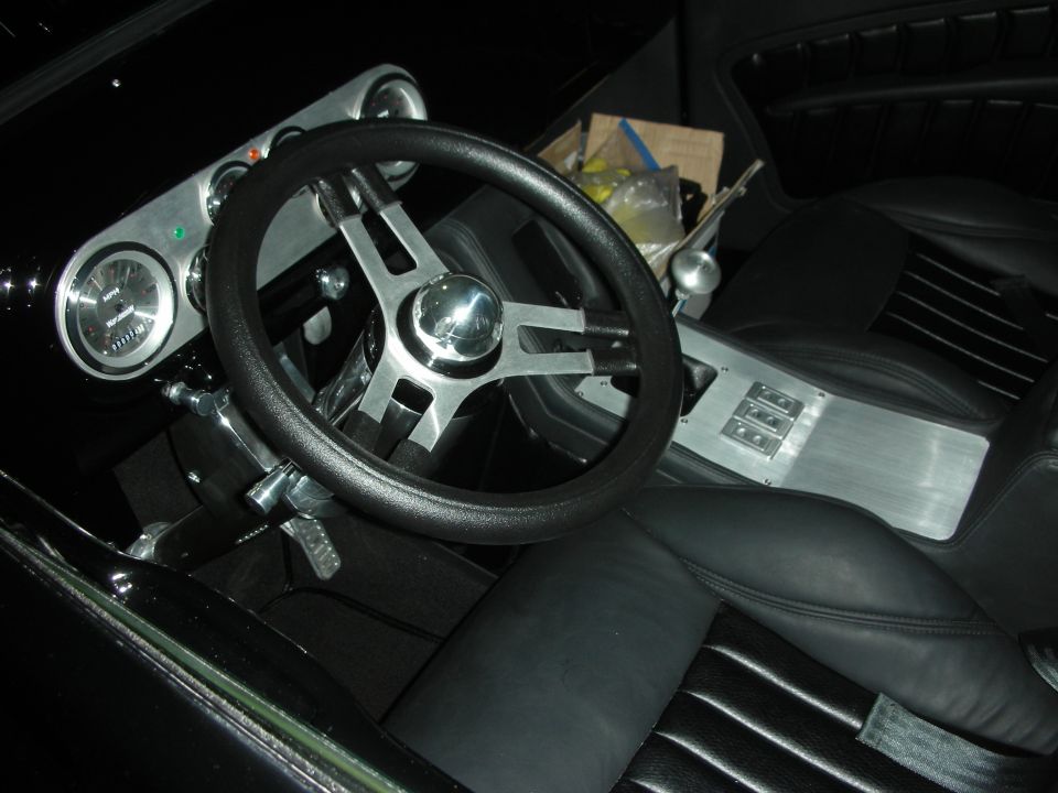 Custom interior with black leather seats, brushed center console and three-spoke wheel