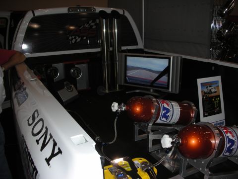 1998 Ford Crown Victoria - show display in a truck bed featuring two orange nitrous bottles, audio components, a video monitor, and a Sony-branded white panel.
