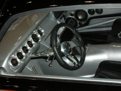 1998 Ford Crown Victoria - custom car cockpit featuring a row of round analog gauges, a black sport steering wheel, and a silver dashboard.