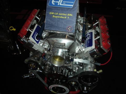1998 Ford Crown Victoria - polished GM LS-series V8 with ERL Performance Superdeck branding, red coil covers and a center throttle body on display.