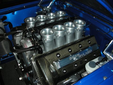 1998 Ford Crown Victoria - carbon-covered Sean Hyland V8 topped with eight individual velocity-stack throttle bodies sits in a glossy blue engine bay.