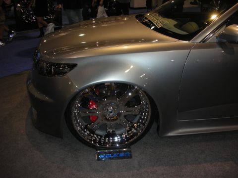 1998 Ford Crown Victoria - lowered silver sedan shown front-quarter sitting on a large chrome multi-spoke wheel with a red caliper and a Falken display plate.