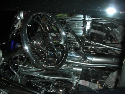 1998 Ford Crown Victoria - Close-up of a polished chrome billet steering wheel set against an elaborate polished tubular chassis.