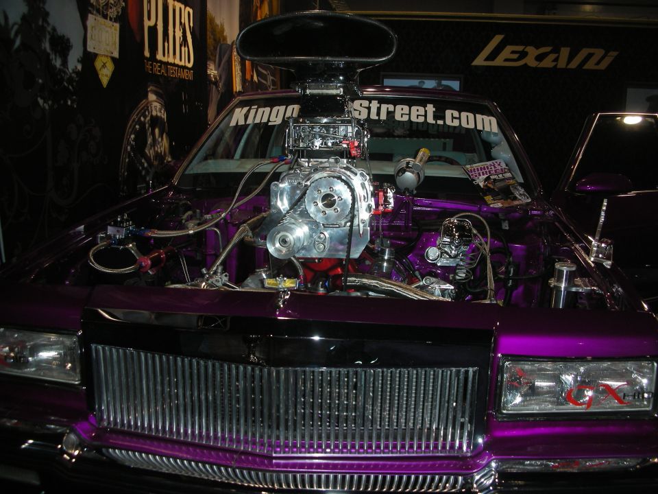 Purple lowrider with chrome blown engine and KingoftheStreet.com windshield text