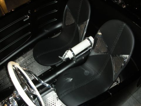 1998 Ford Crown Victoria - Overhead view of two black bucket seats with mesh inserts and a white steering wheel in an open custom car interior.