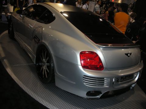 1998 Ford Crown Victoria - silver Bentley Continental coupe on a turntable shows its custom body kit, black multi-spoke wheels, and a Platinum display plate.