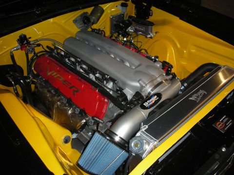 1998 Ford Crown Victoria - Engine bay of a yellow car holding a Viper V10 engine with red valve covers, a polished intake and blue filter.