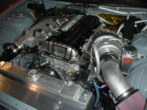1998 Ford Crown Victoria - polished turbocharged engine swap with intercooler piping, cone filter and a Griffin radiator in a custom engine bay.