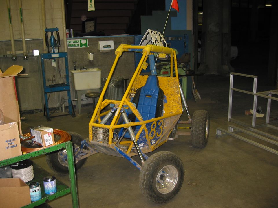 Yellow off-road buggy with blue seat and red flag on top