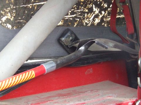 1990 Ford Bronco - Interior view of a vehicle showing a shovel and part of a roll cage.
